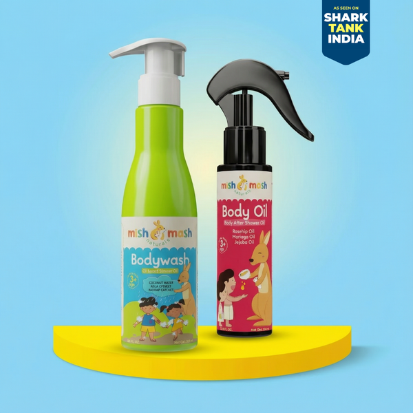 Two children's skincare products, bodywash and body oil, on a yellow platform with a blue background. Shark Tank India logo visible.