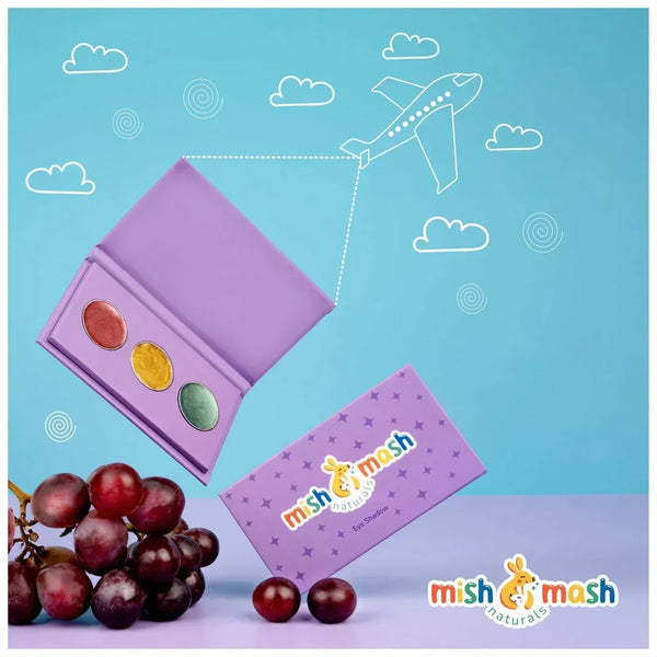 Purple makeup palette with colorful shades, grapes, and a plane illustration on a blue background.